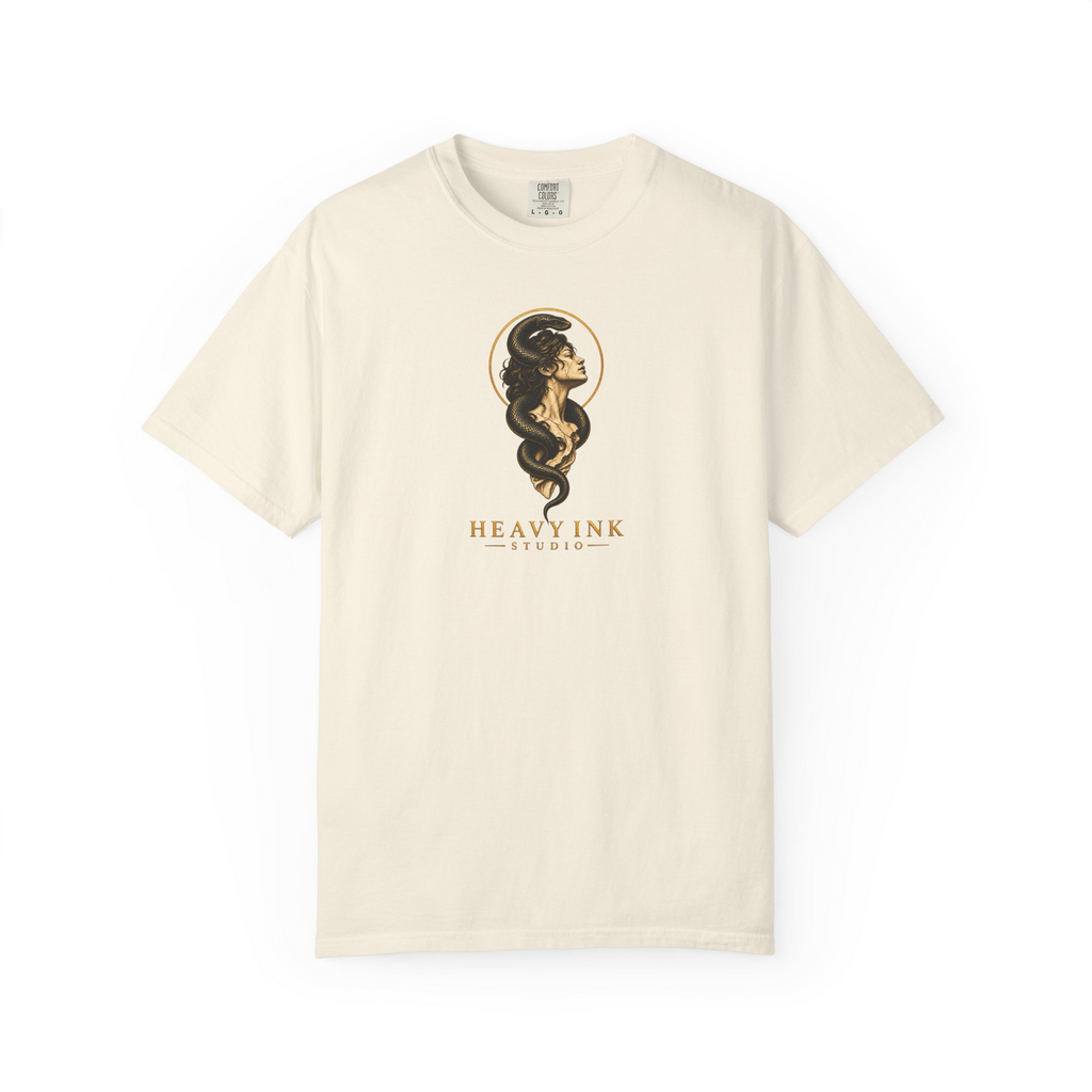 Gilded Serpent tee in Ivory, front view with a centered classical bust, black serpent, gold halo and Heavy Ink Studio wordmark